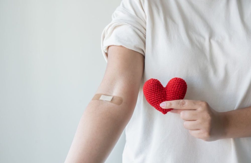 Blood donation concept. Give blood save up to three lives. Woman arm with the bandage plaster showing as a blood donation volunteer.